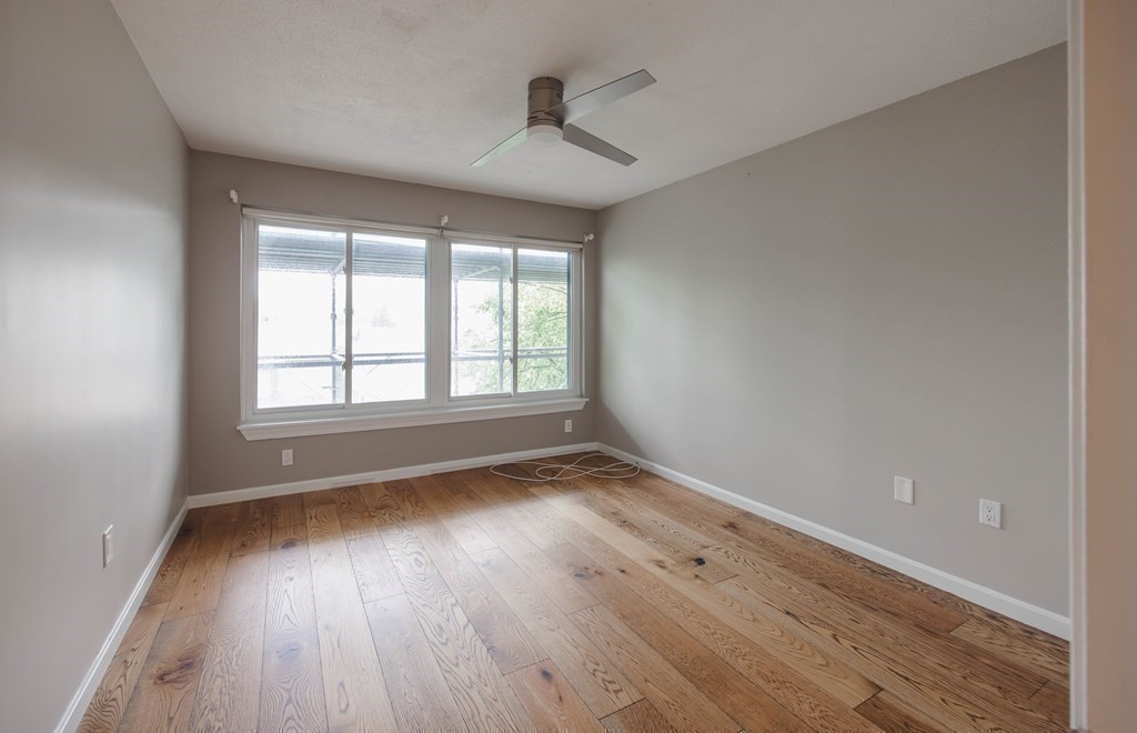 59 Brainerd Road, Unit 407 Boston, MA 02134 - Photo 11 of 22 wooden floor in an empty room with a window