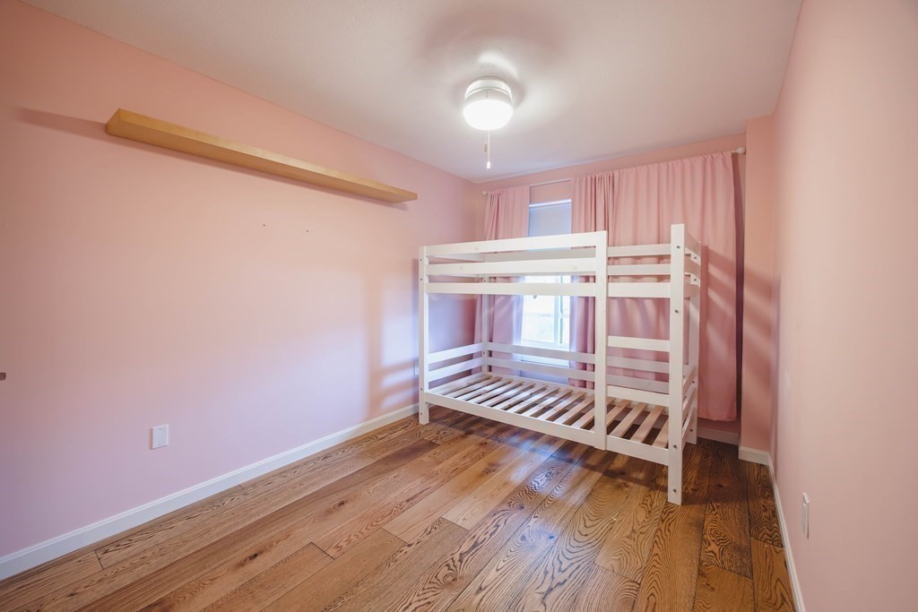59 Brainerd Road, Unit 407 Boston, MA 02134 - Photo 13 of 22 a view of room with wooden floor and white walls