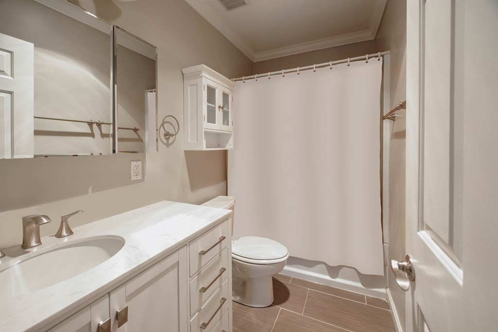 59 Brainerd Road, Unit 407 Boston, MA 02134 - Photo 15 of 22 a bathroom with a granite countertop sink toilet and shower