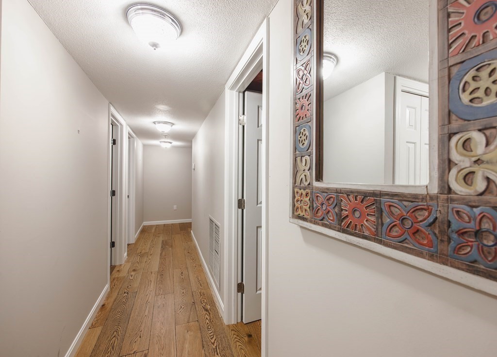 59 Brainerd Road, Unit 407 Boston, MA 02134 - Photo 17 of 22 a view of a hallway with wooden floor