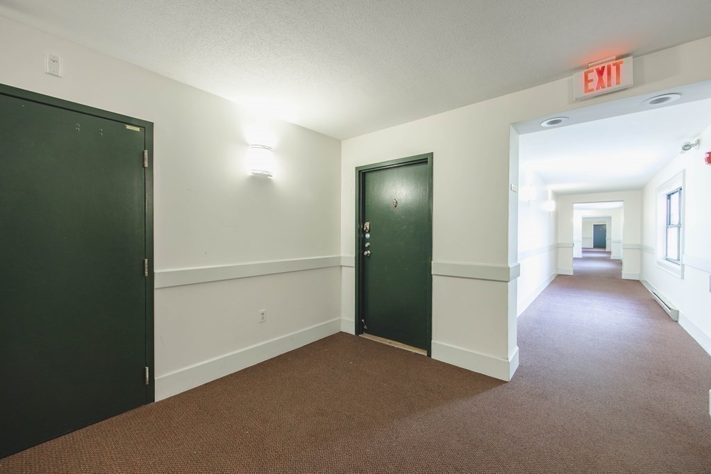 59 Brainerd Road, Unit 407 Boston, MA 02134 - Photo 20 of 22 a view of a hallway with wooden floor and closet