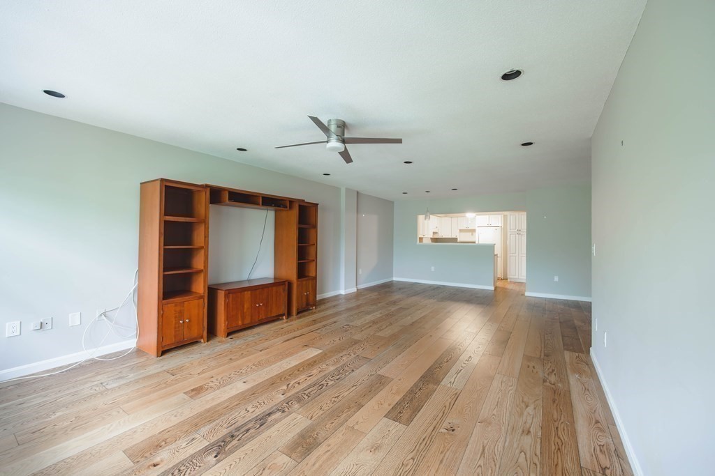 59 Brainerd Road, Unit 407 Boston, MA 02134 - Photo 8 of 22 an empty room with a window and wooden floor