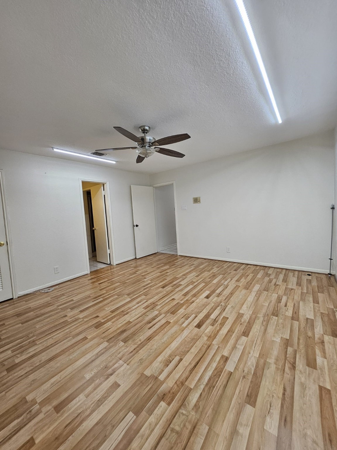9415 Spellman Road Houston, TX 77031 - Photo 15 of 26 a view of empty room with wooden floor and fan
