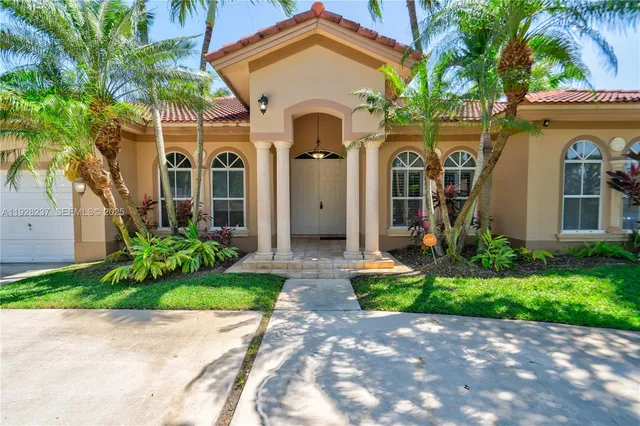 a front view of a house with garden