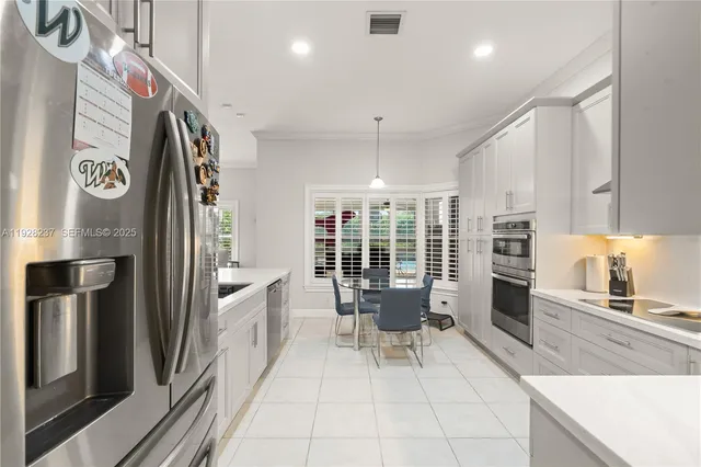 a large white kitchen with a large window