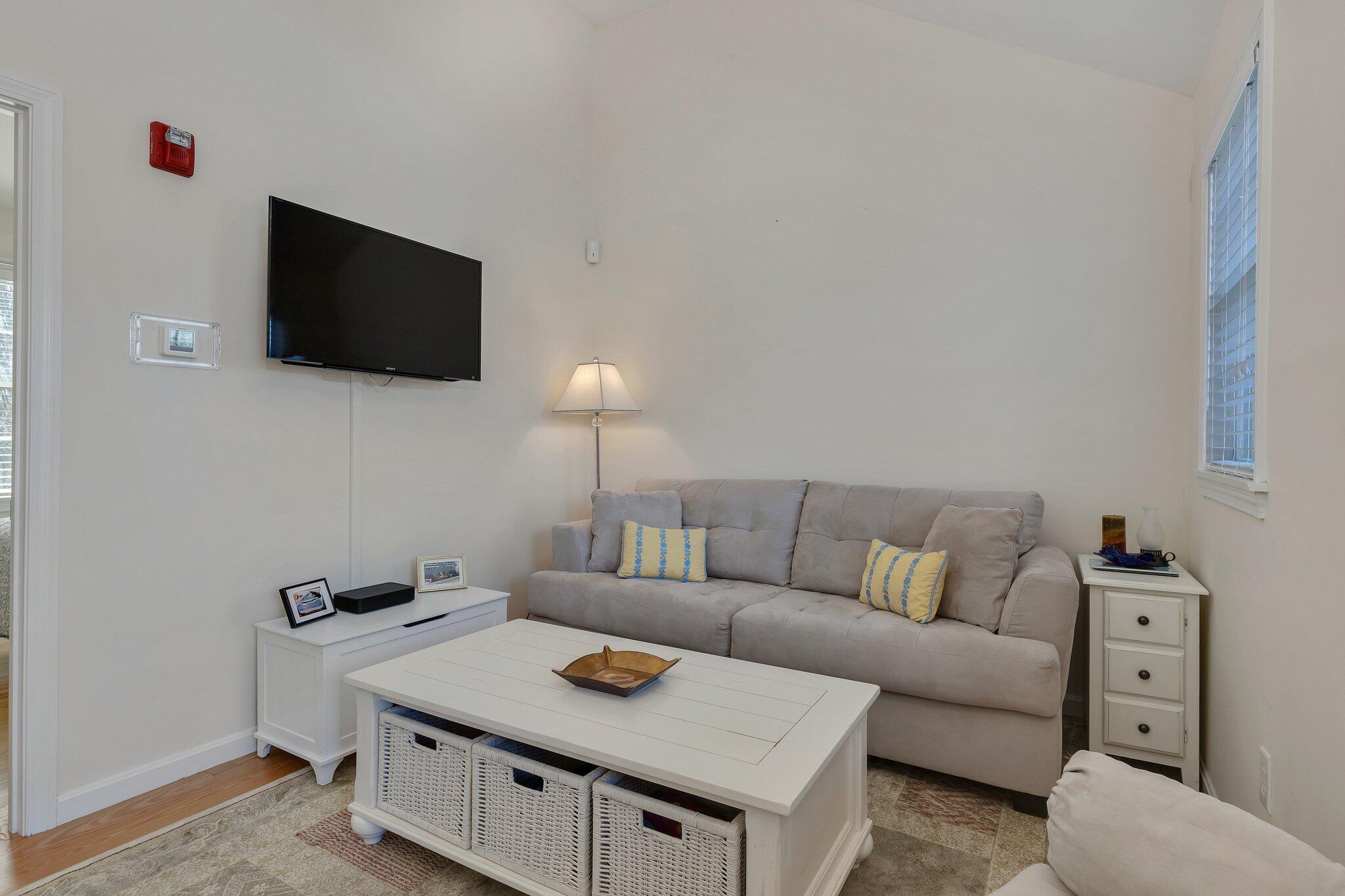 6 Shore Road, Unit 19 Truro, MA 02666 - Photo 3 of 21 a living room with furniture and a flat screen tv