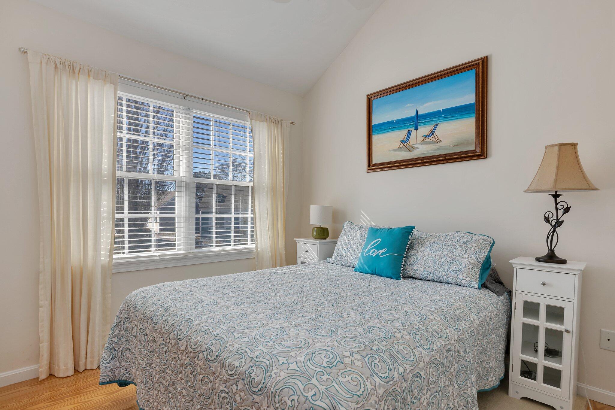 6 Shore Road, Unit 19 Truro, MA 02666 - Photo 8 of 21 a bedroom with a large bed and a window