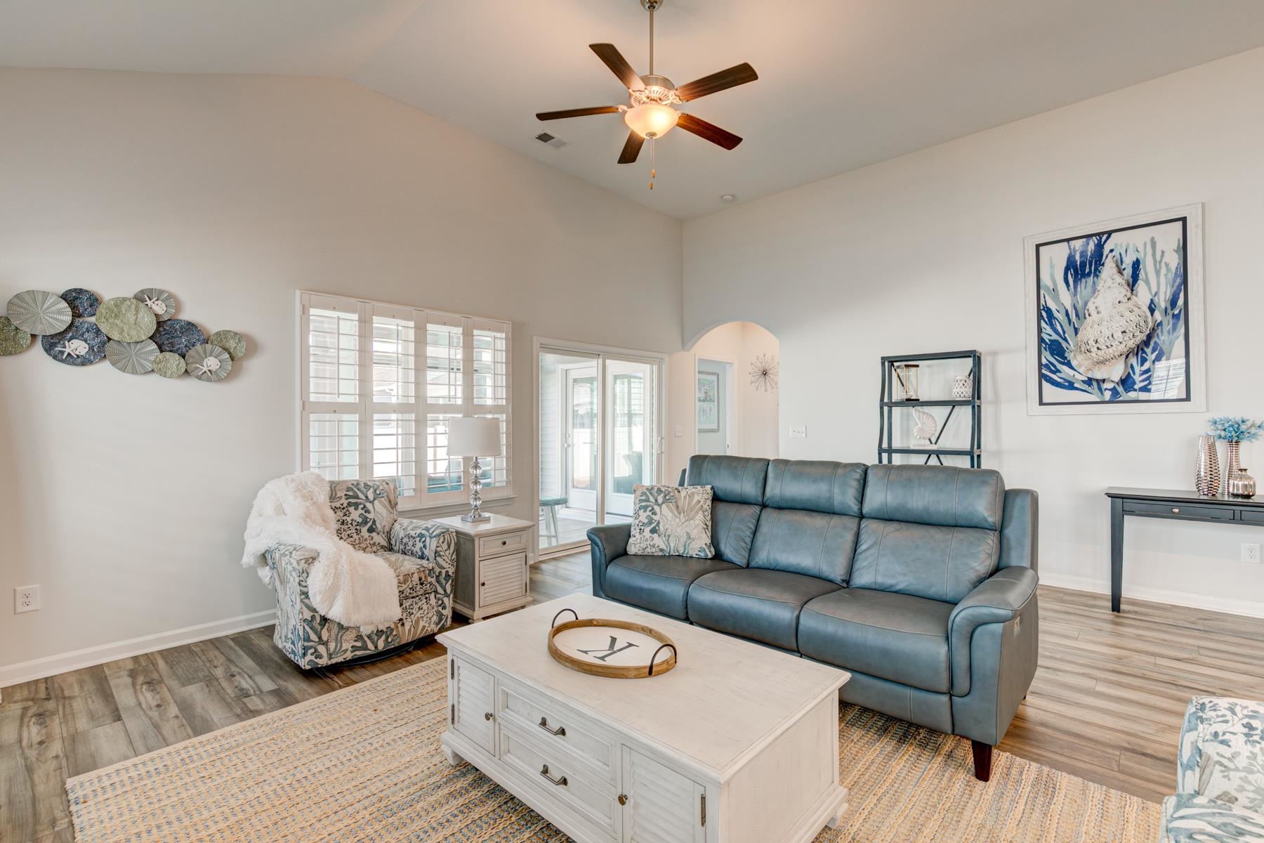 417 Heathside Street Murrells Inlet, SC 29576 - Photo 12 of 40 Living area with arched walkways, light wood finished floors, ceiling fan, and high vaulted ceiling