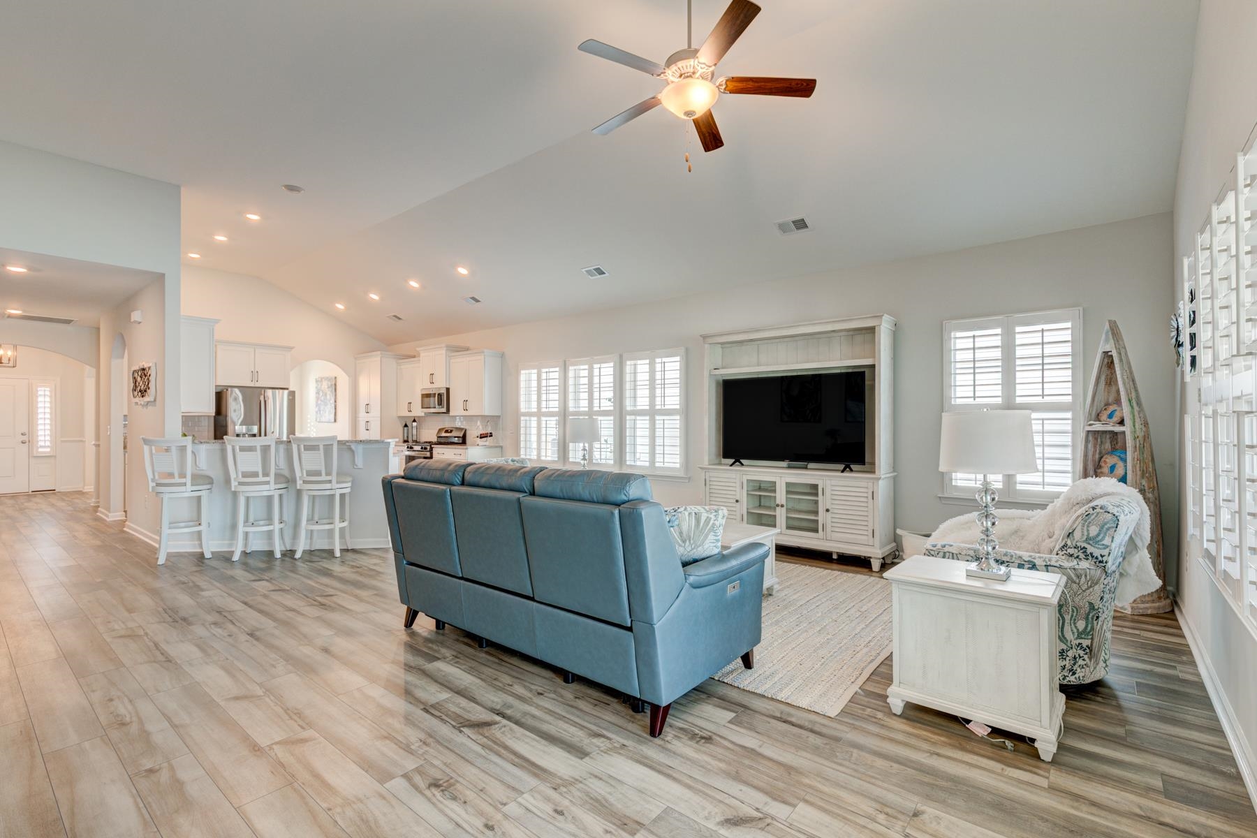 417 Heathside Street Murrells Inlet, SC 29576 - Photo 14 of 40 Living area featuring high vaulted ceiling, light wood-style floors, ceiling fan, arched walkways, and recessed lighting