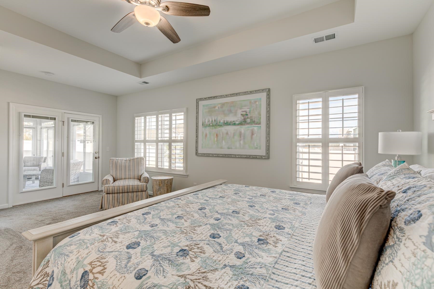 417 Heathside Street Murrells Inlet, SC 29576 - Photo 20 of 40 Bedroom featuring a tray ceiling, access to outside, carpet floors, and a ceiling fan