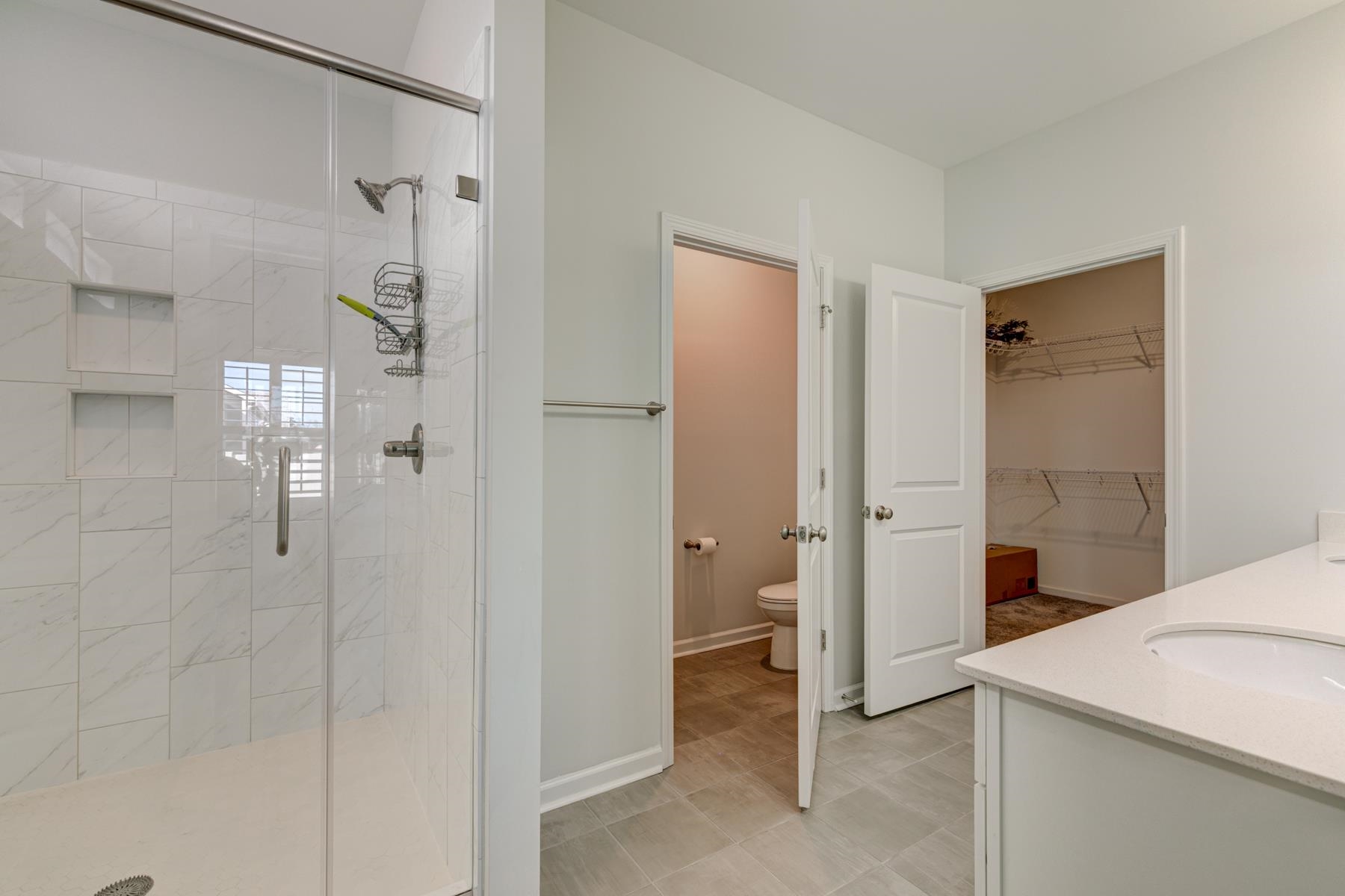 417 Heathside Street Murrells Inlet, SC 29576 - Photo 21 of 40 Bathroom with vanity, a shower stall, and a walk in closet