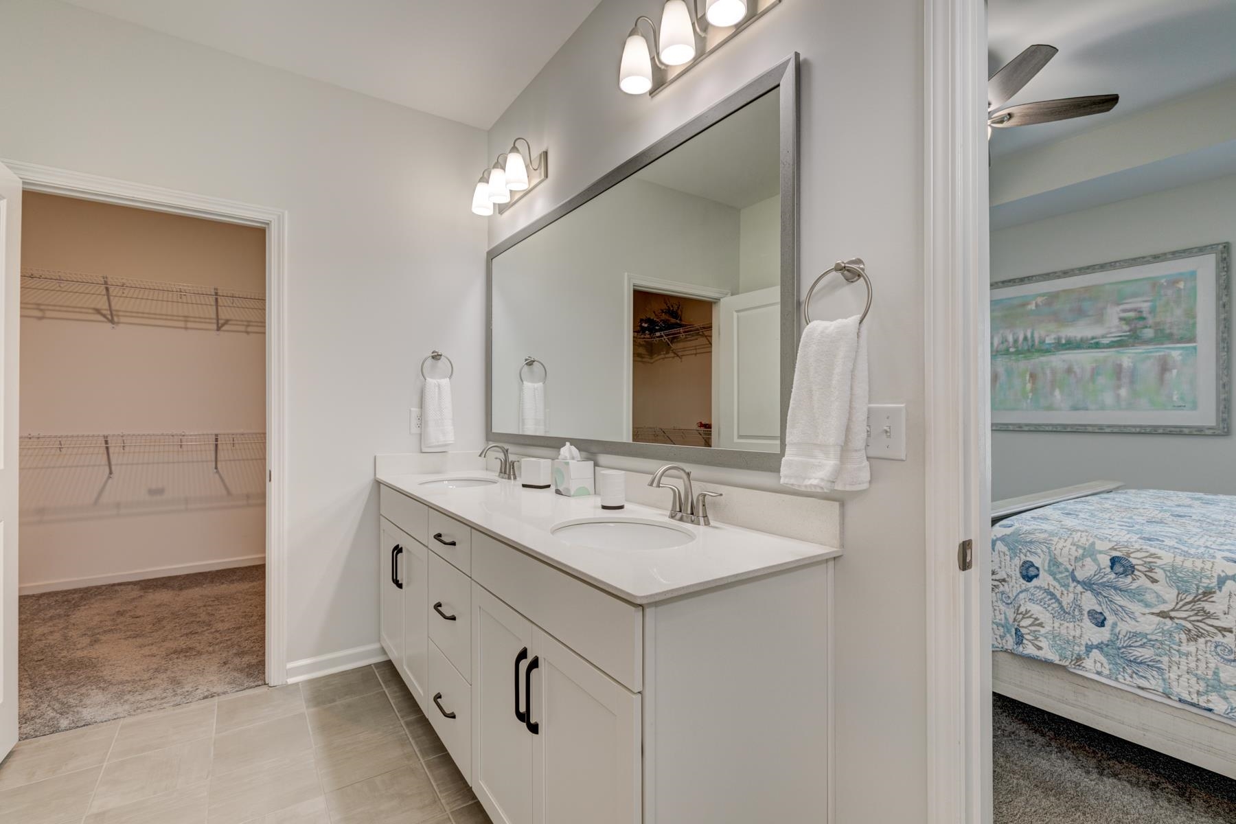 417 Heathside Street Murrells Inlet, SC 29576 - Photo 23 of 40 Ensuite bathroom with double vanity, a spacious closet, light colored carpet, light tile patterned floors, and a ceiling fan