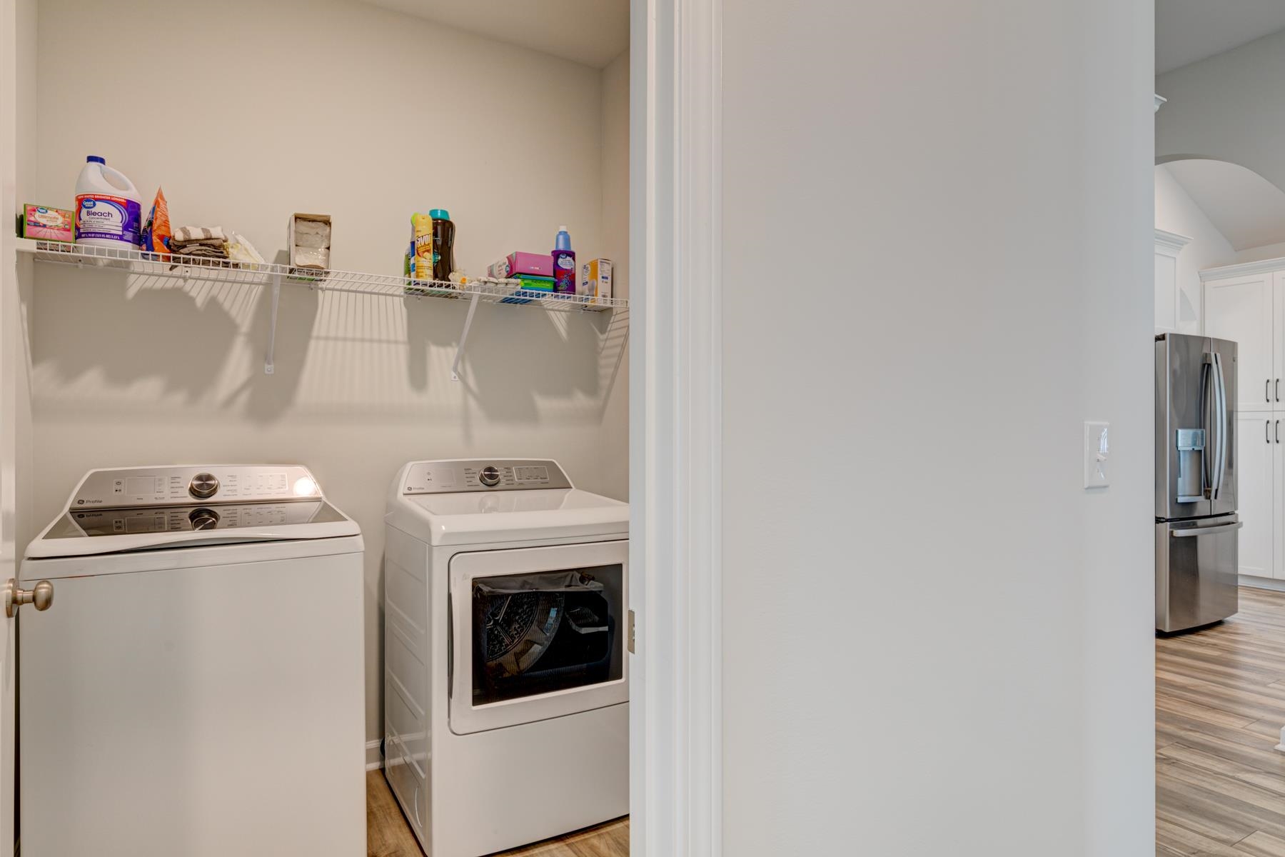 417 Heathside Street Murrells Inlet, SC 29576 - Photo 38 of 40 Laundry room with light wood finished floors, washer and clothes dryer, and arched walkways