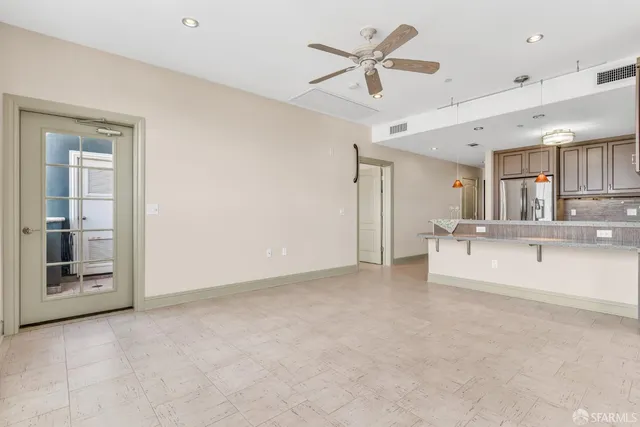 a living room with furniture a table and kitchen view