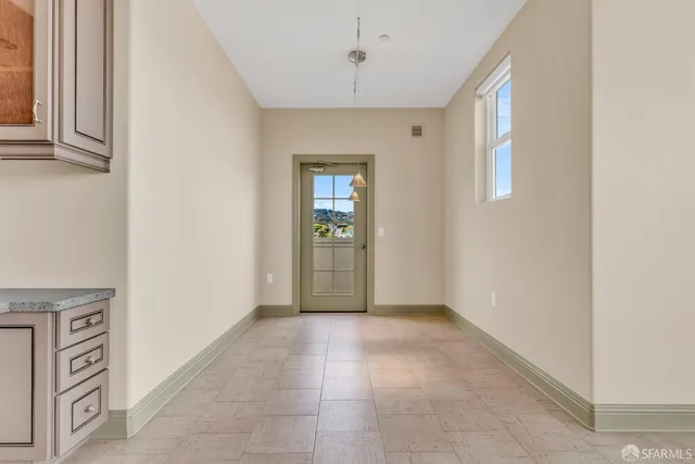 a kitchen with stainless steel appliances granite countertop a sink and a refrigerator