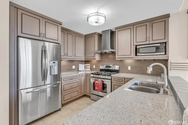 a bedroom with a large bed and a potted plant