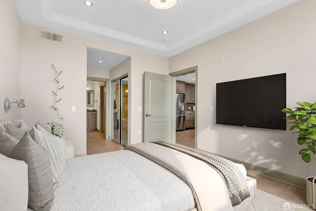 a view of a hallway with wooden floor and a bathroom