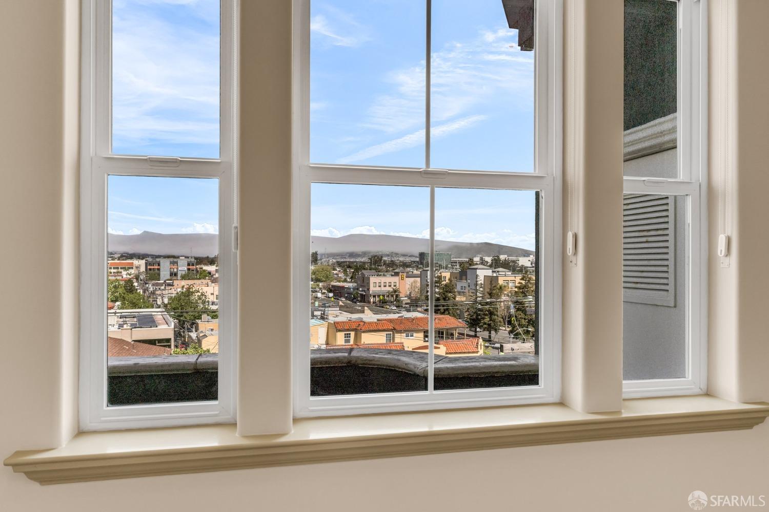 151 El Camino Real, Unit 402 Millbrae, CA 94030 - Photo 29 of 43 a view of a glass door with a city view