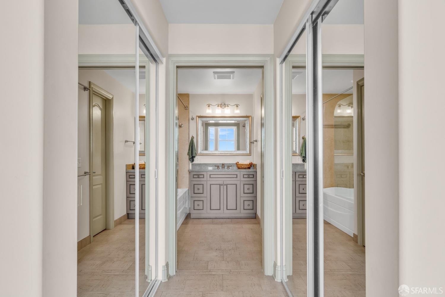 151 El Camino Real, Unit 402 Millbrae, CA 94030 - Photo 31 of 43 a view of a hallway with wooden floor and a bathroom