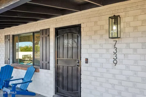 a bathroom with a granite countertop sink toilet and mirror
