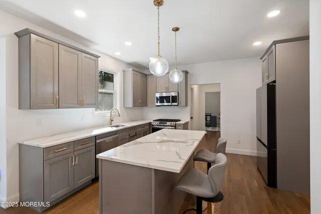 a kitchen with a table chairs refrigerator and microwave