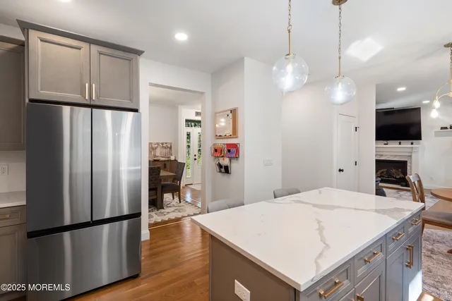 a kitchen with stainless steel appliances a refrigerator sink and fireplace