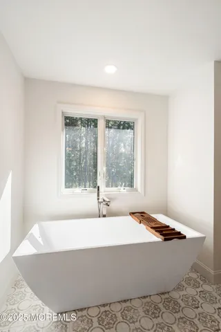 a bathroom with a bathtub and window