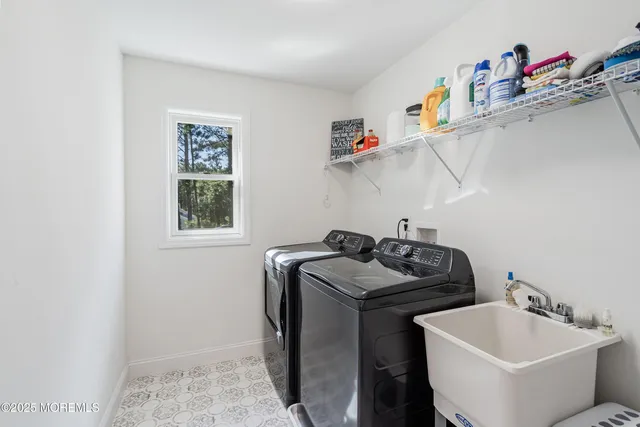 a utility room with sink dryer and washer