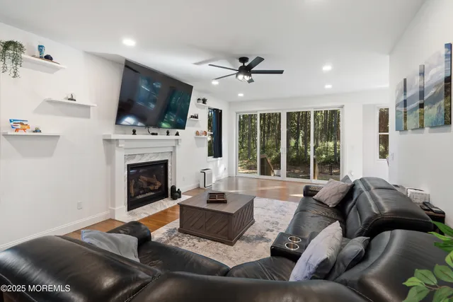 a living room with furniture fireplace and flat screen tv