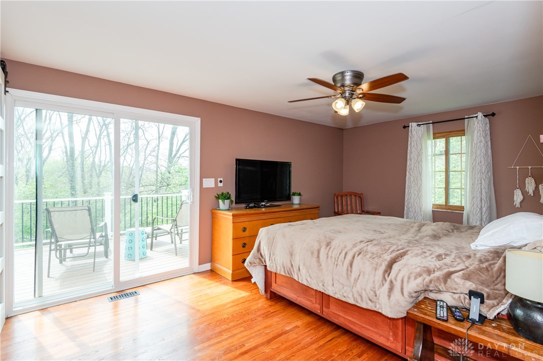 728 Chipplegate Drive Centerville, OH 45459 - Photo 15 of 30 Bright bedroom with warm wood flooring and access to a private outdoor deck.