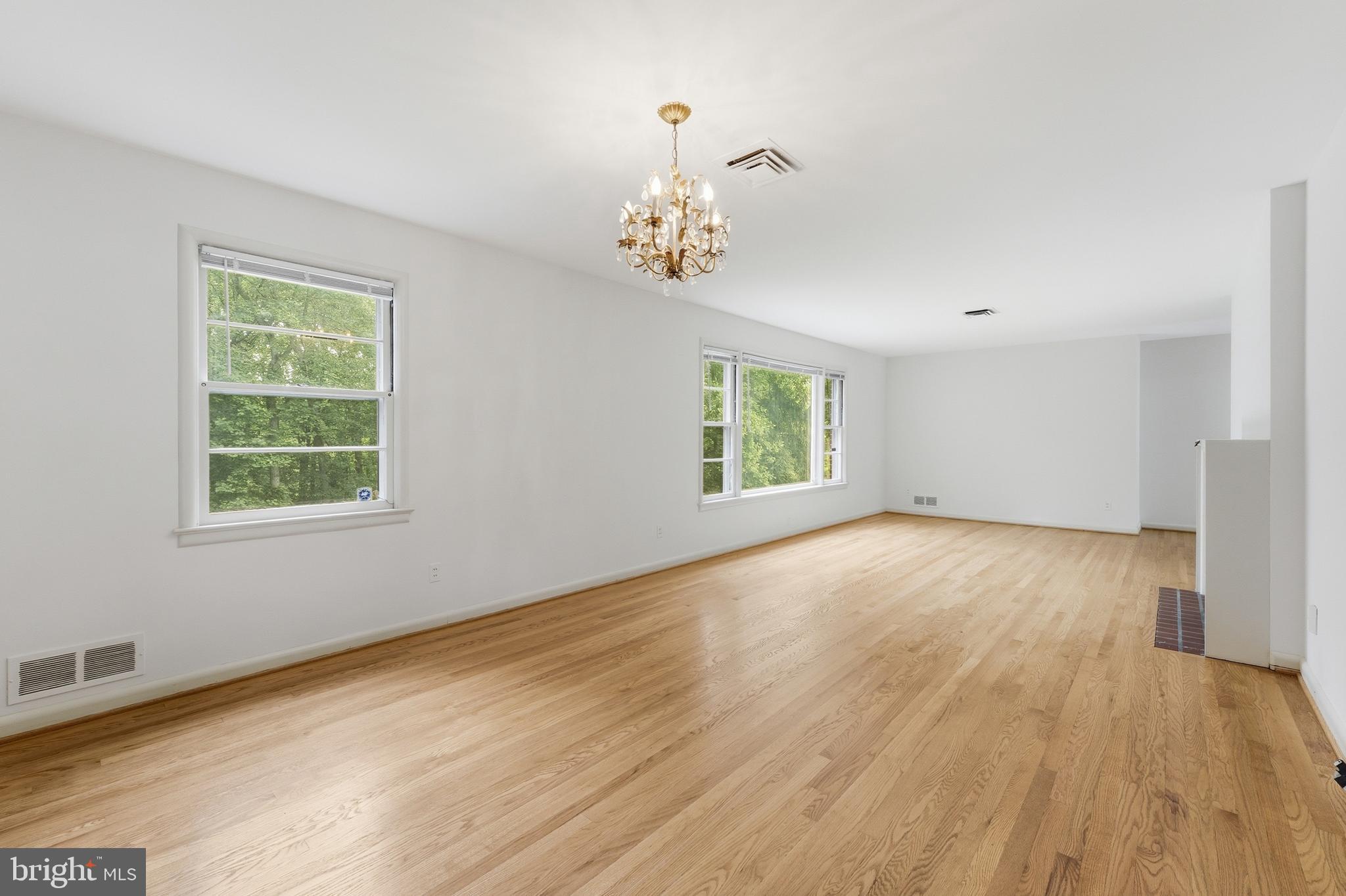 228 Northwest Terrace Silver Spring, MD 20901 - Photo 15 of 70 a view of an empty room with a window and wooden floor