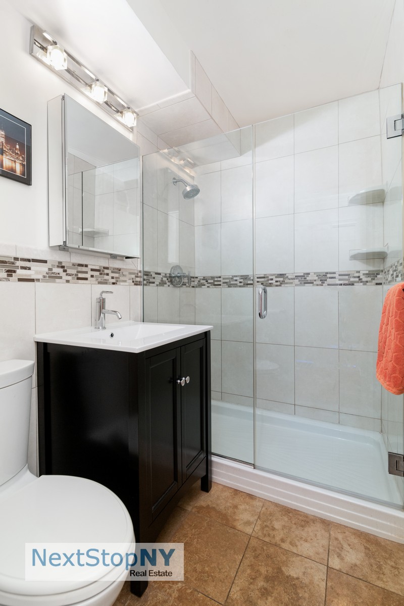 235 East 57th Street, Unit 11C Manhattan, NY 10022 - Photo 6 of 10 a bathroom with a sink and a mirror