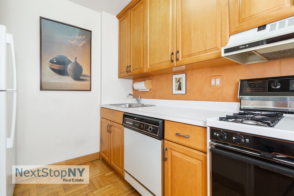 235 East 57th Street, Unit 11C Manhattan, NY 10022 - Photo 8 of 10 a view of a kitchen with stove and cabinets