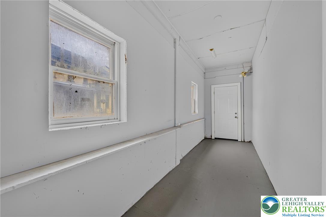 313 Main Street Slatington, PA 18080 - Photo 36 of 73 A well-lit corridor with durable flooring and multiple windows offers functional space.