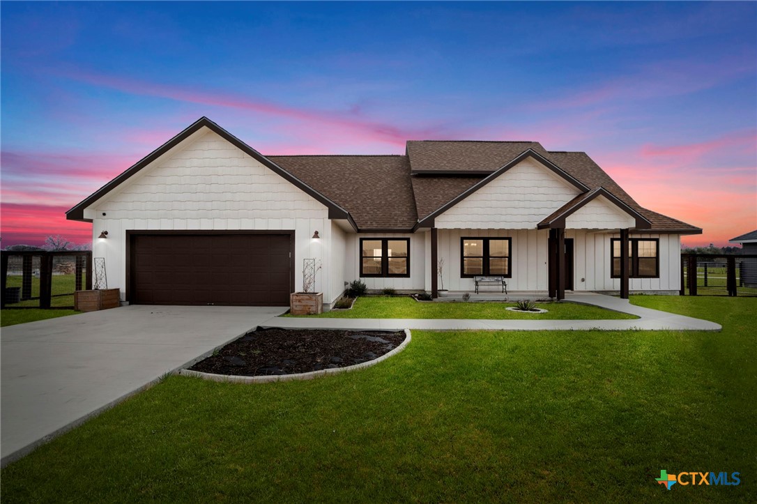 a front view of a house with a yard and porch