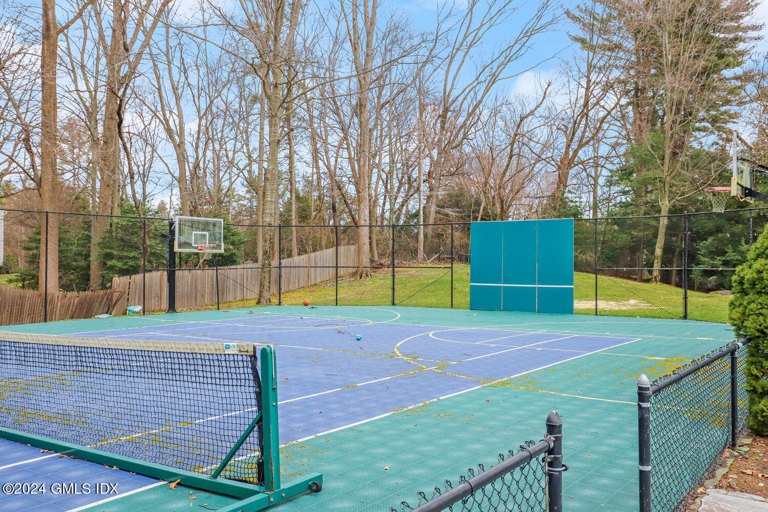 2 Lauder Way Greenwich, CT 06830 - Photo 16 of 25 a view of a tennis ground with trees in the background