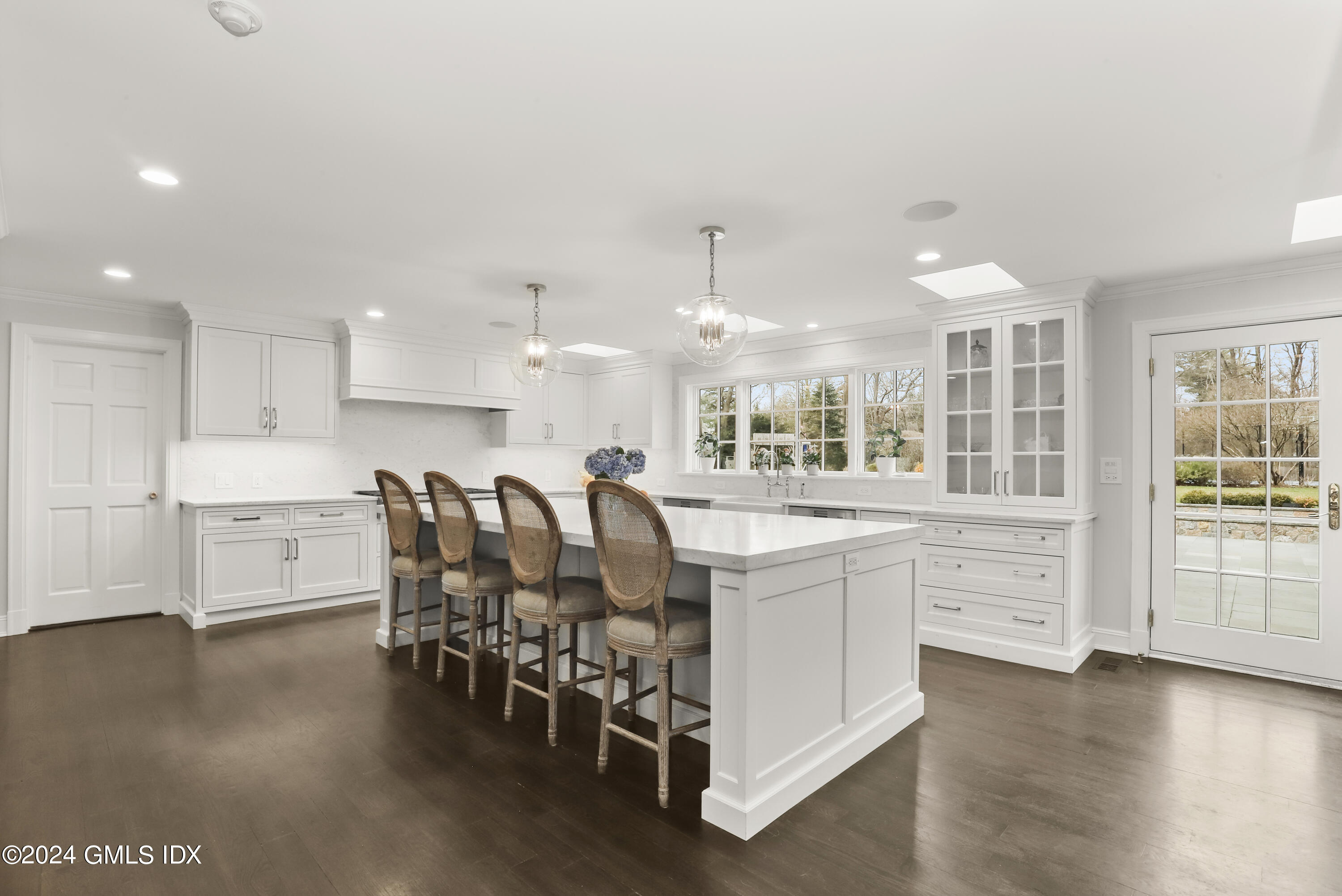 2 Lauder Way Greenwich, CT 06830 - Photo 6 of 25 a kitchen with stainless steel appliances kitchen island granite countertop a table chairs sink and cabinets