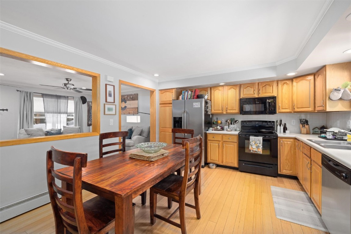 239 Huron Road, Unit C14 Breckenridge, CO 80424 - Photo 8 of 25 a kitchen with stainless steel appliances granite countertop a stove top oven a sink dishwasher a dining table and chairs with wooden floor