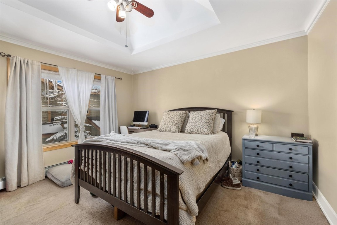 239 Huron Road, Unit C14 Breckenridge, CO 80424 - Photo 9 of 25 a bedroom with a bed and a chandelier