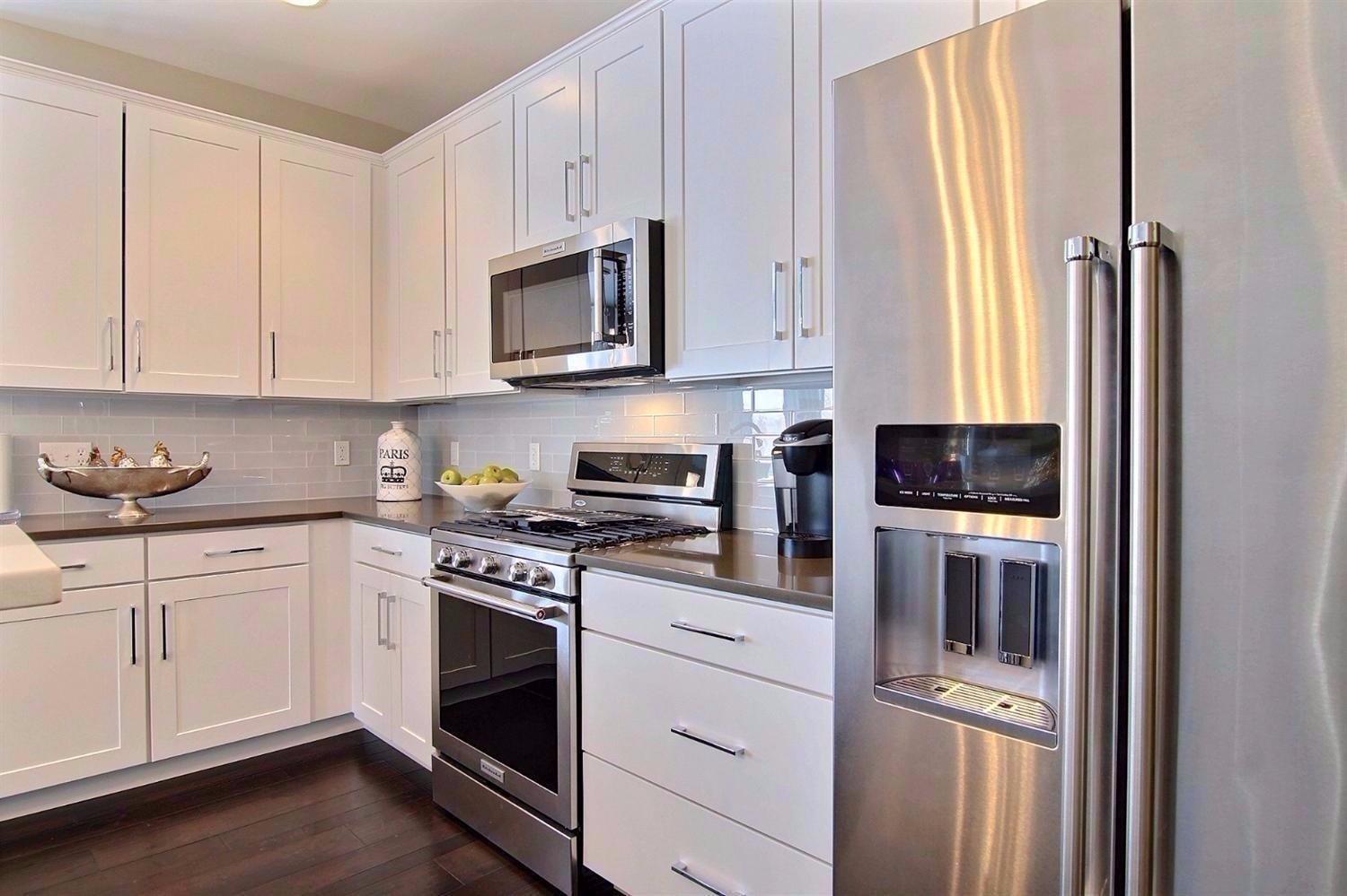 5833 Burr Rdg Circle Crown Point, IN 46307 - Photo 8 of 19 a kitchen with stainless steel appliances granite countertop a stove a sink and a refrigerator