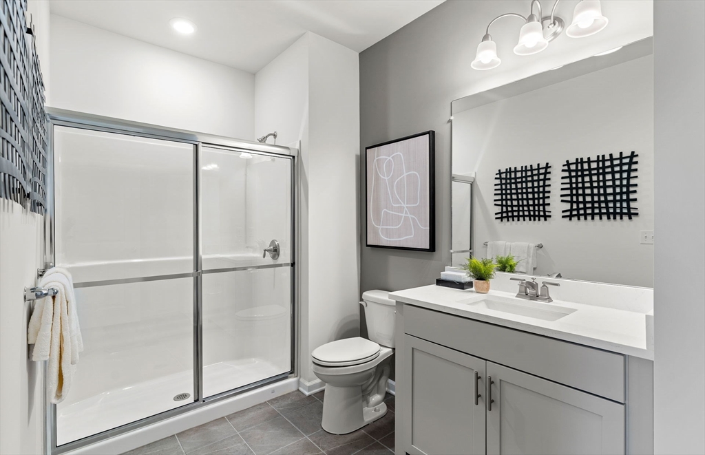 6 Stratton Drive, Unit 208 Woburn, MA 01801 - Photo 20 of 22 a bathroom with a sink toilet and shower