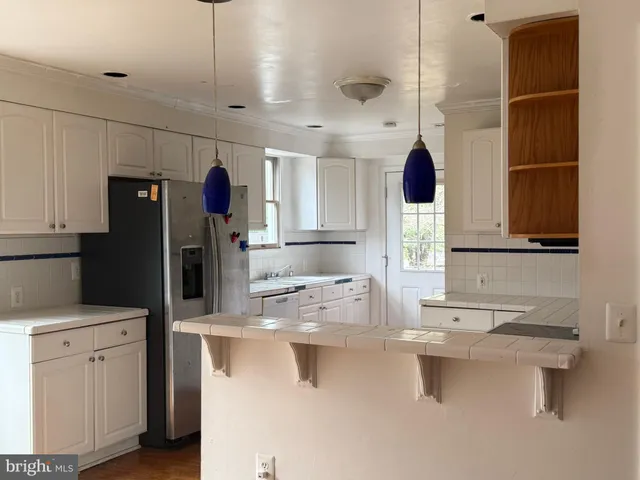 a kitchen with a sink and refrigerator
