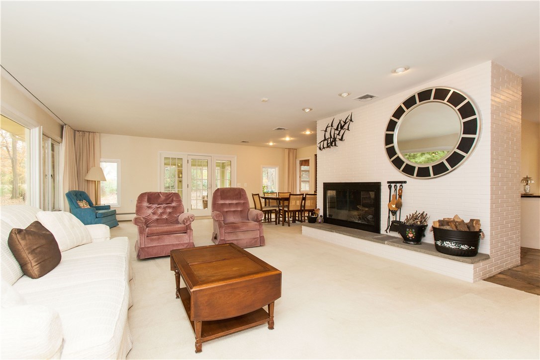 133 Forge Road North Kingstown, RI 02852 - Photo 7 of 35 Living room with large stone fireplace and opens to the formal dining room.