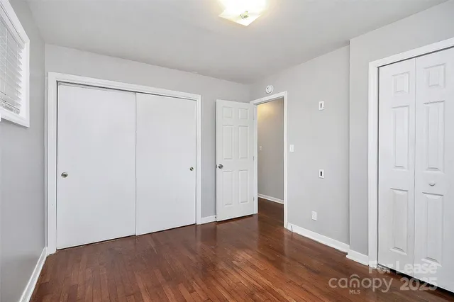 a view of an empty room and wooden floor