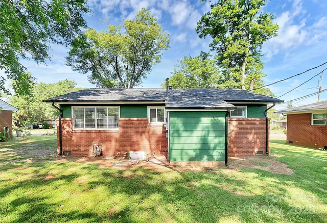 a front view of a house with a garden and yard