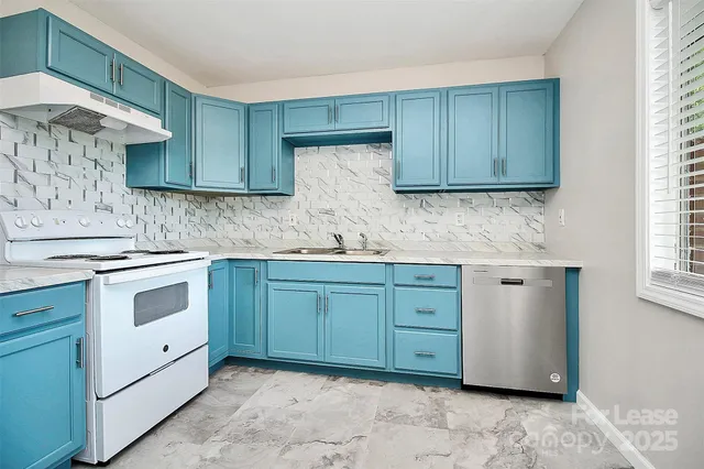 a kitchen with granite countertop cabinets stainless steel appliances and sink