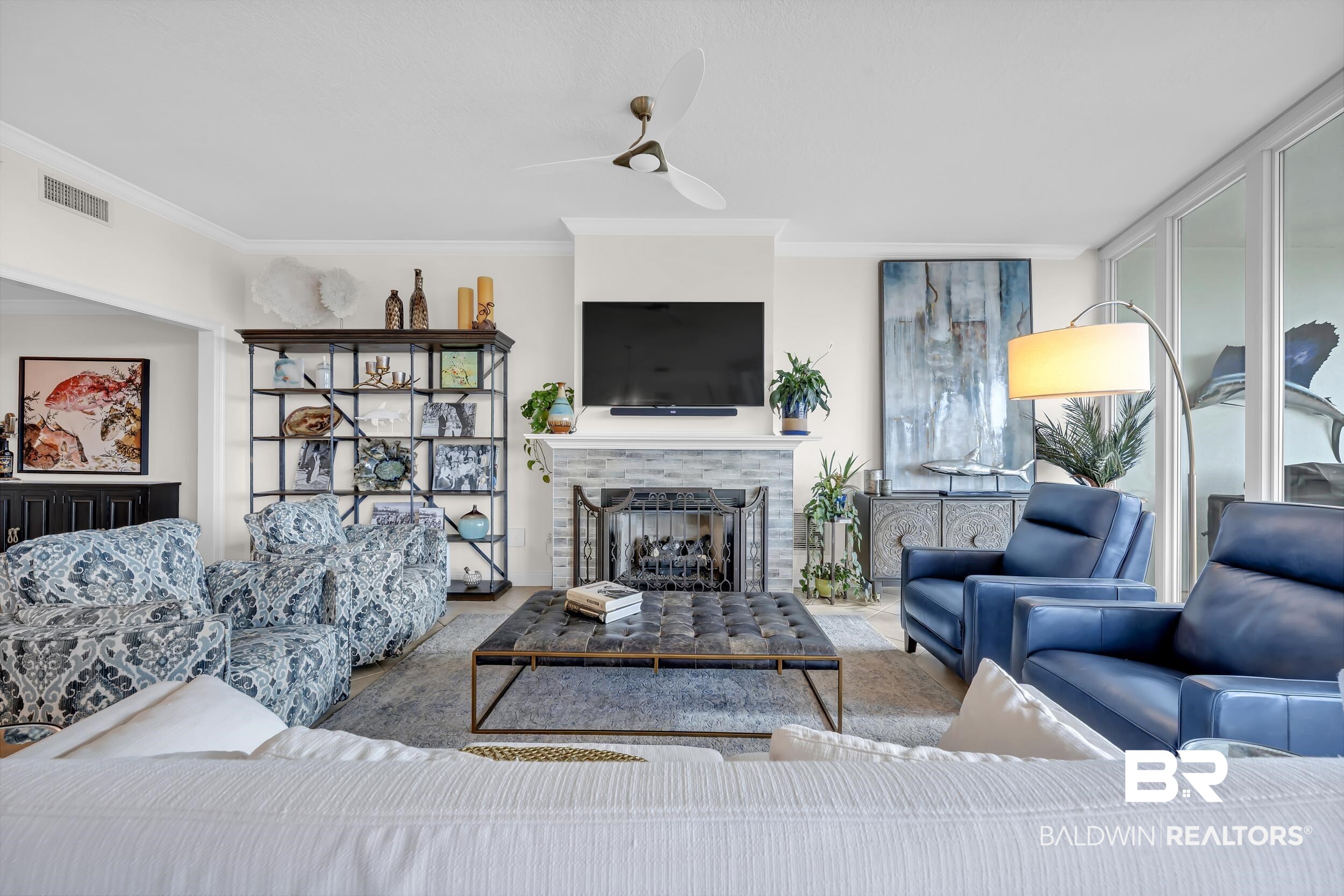 28250 Canal Road, Unit 307 Orange Beach, AL 36561 - Photo 29 of 56 Living area with a fireplace, ceiling fan, and crown molding