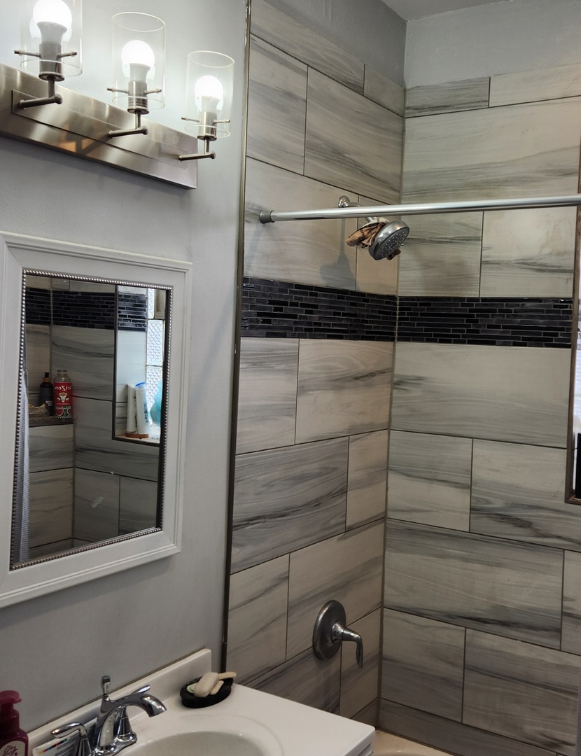 7927 South Justine Street Chicago, IL 60620 - Photo 5 of 9 a bathroom with a sink and a mirror