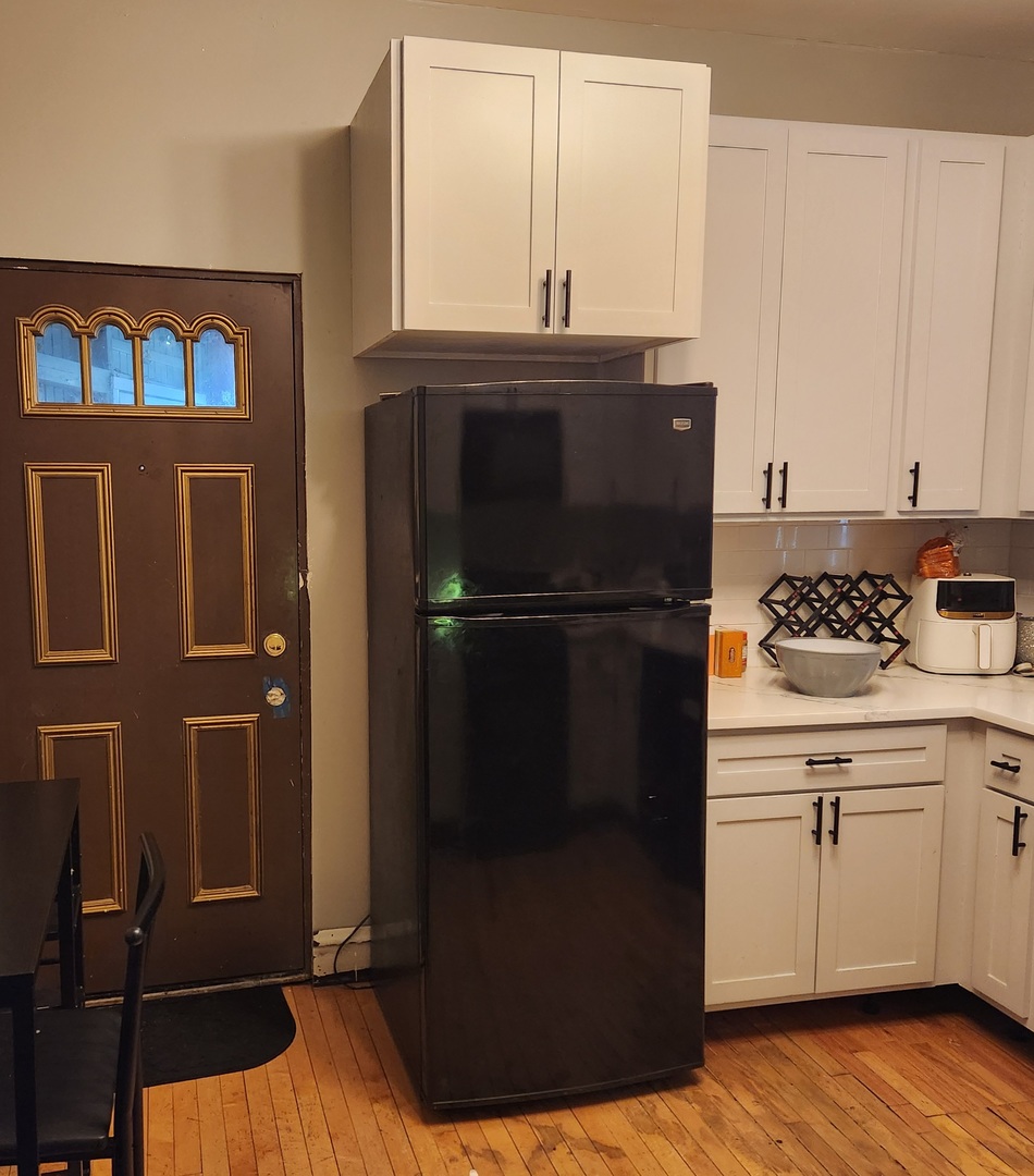7927 South Justine Street Chicago, IL 60620 - Photo 6 of 9 a kitchen with a refrigerator and cabinets