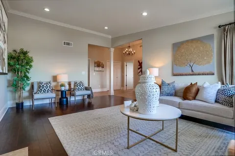 a kitchen with a dining table chairs cabinets and wooden floor